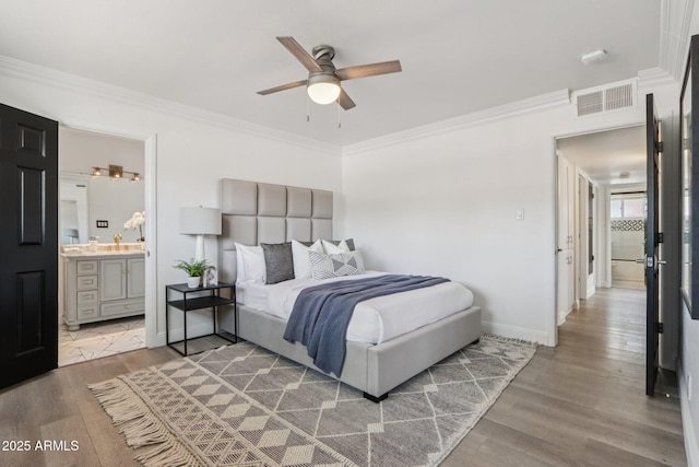 7049 E Latham St, Scottsdale, AZ 85257 - bedroom featuring wood finished floors, ornamental molding, baseboards, connected bathroom, and a ceiling fan