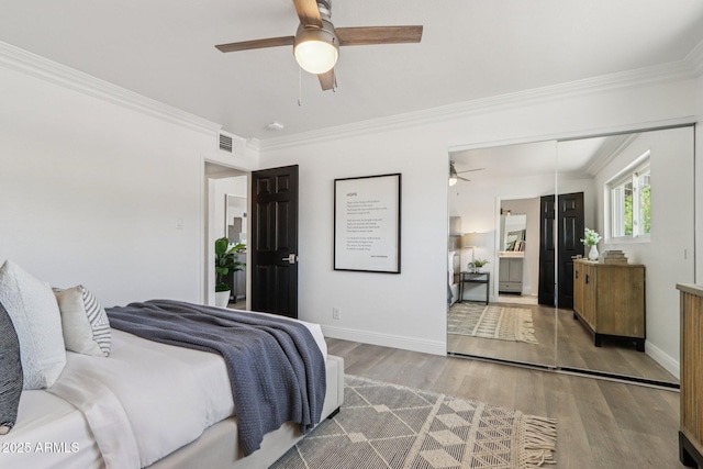 7049 E Latham St, Scottsdale, AZ 85257 - bedroom with wood finished floors, crown molding, baseboards, and a ceiling fan