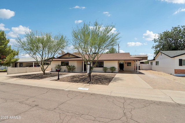 7049 E Latham St, Scottsdale, AZ 85257 - view of front of house featuring concrete driveway and stucco siding