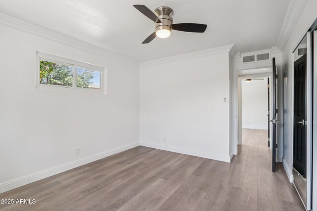 7049 E Latham St, Scottsdale, AZ 85257 - empty room featuring ceiling fan, crown molding, wood finished floors, and baseboards