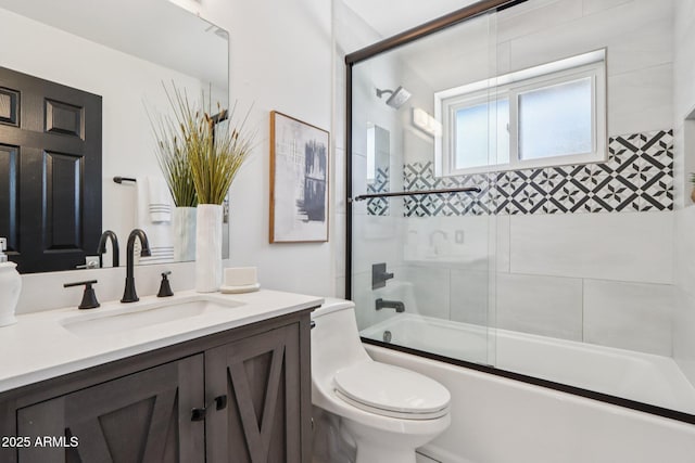 7049 E Latham St, Scottsdale, AZ 85257 - bathroom featuring vanity, shower / bath combination with glass door, and toilet