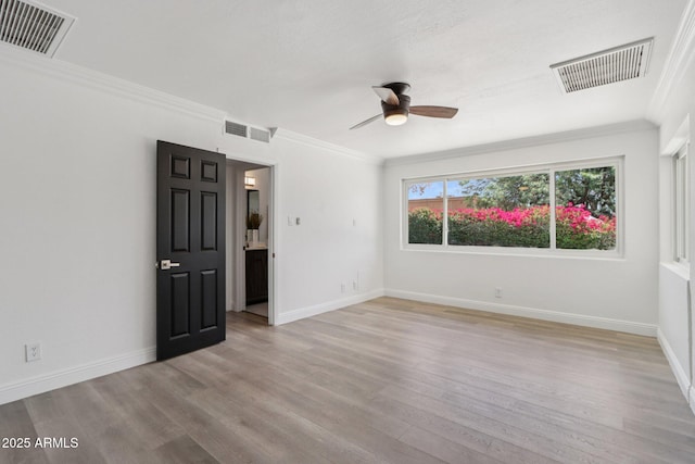 7049 E Latham St, Scottsdale, AZ 85257 - unfurnished room featuring light wood-style floors, ornamental molding, a ceiling fan, and baseboards