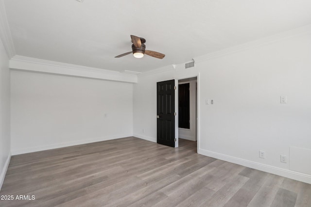 7049 E Latham St, Scottsdale, AZ 85257 - spare room featuring crown molding, wood finished floors, a ceiling fan, and baseboards