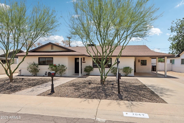 7049 E Latham St, Scottsdale, AZ 85257 - ranch-style house with driveway, stucco siding, and a carport