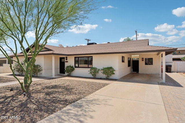 7049 E Latham St, Scottsdale, AZ 85257 - ranch-style house with an attached carport, stucco siding, concrete driveway, and a shingled roof