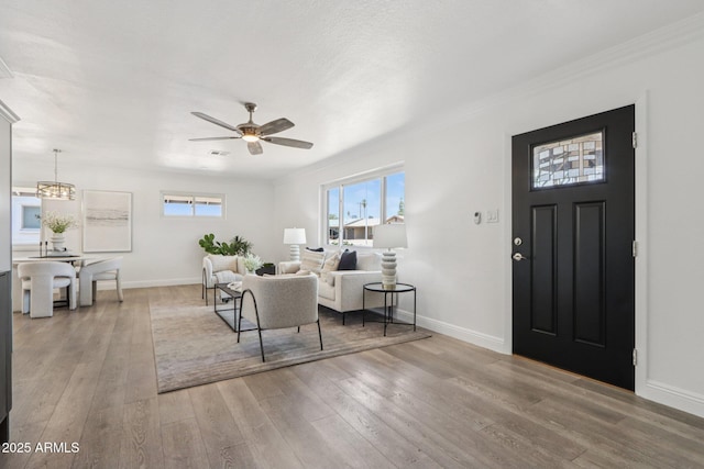 7049 E Latham St, Scottsdale, AZ 85257 - living area featuring baseboards, light wood-style flooring, ceiling fan, and ornamental molding