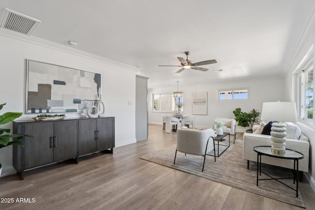 7049 E Latham St, Scottsdale, AZ 85257 - living area with wood finished floors, ceiling fan, crown molding, and baseboards