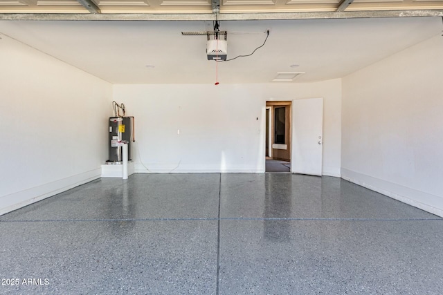 garage with baseboards, electric water heater, and a garage door opener