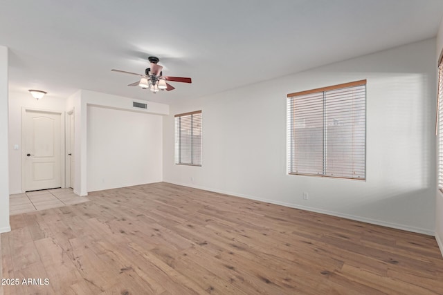 empty room featuring ceiling fan and light hardwood / wood-style flooring