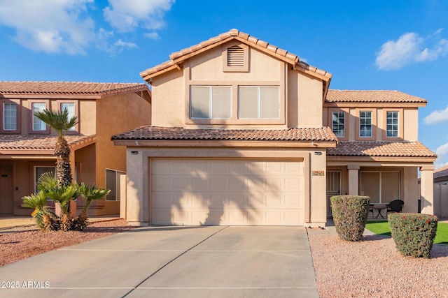 mediterranean / spanish-style house with a garage