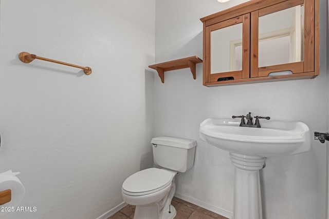 bathroom with tile patterned flooring and toilet