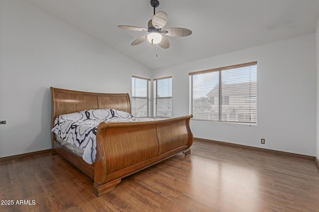 bedroom featuring dark hardwood / wood-style flooring, vaulted ceiling, and ceiling fan