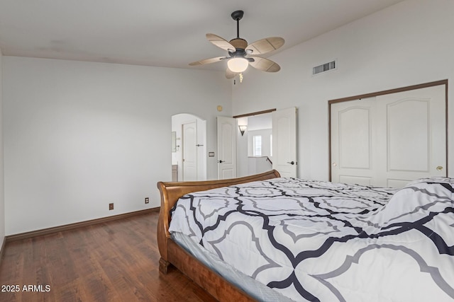 bedroom featuring dark hardwood / wood-style flooring, lofted ceiling, a closet, and ceiling fan