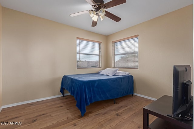 bedroom with hardwood / wood-style flooring and ceiling fan