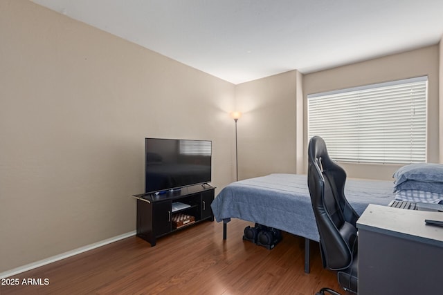 bedroom with dark wood-type flooring