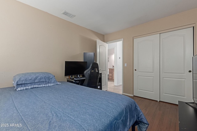 bedroom featuring dark hardwood / wood-style flooring and a closet