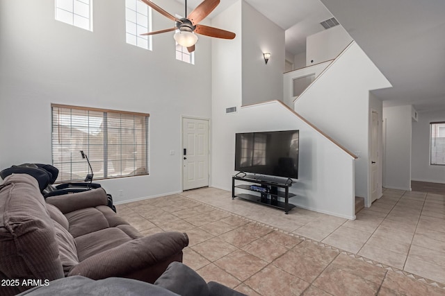 living room featuring light tile patterned flooring and ceiling fan