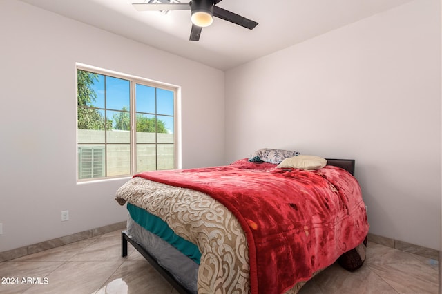 bedroom featuring ceiling fan and light tile patterned floors