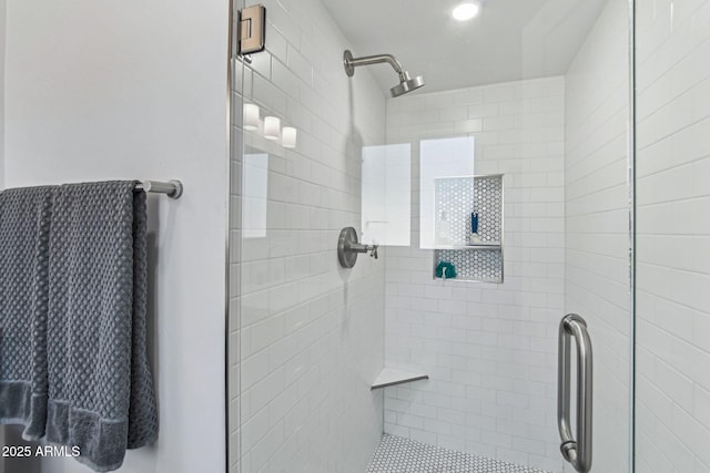 bathroom featuring a shower with door