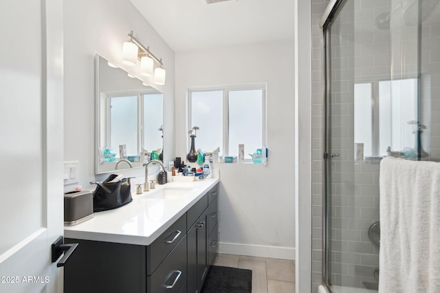 bathroom featuring tile patterned floors, a shower with shower door, and vanity