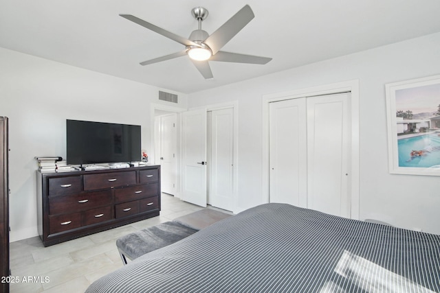 bedroom with multiple closets and ceiling fan