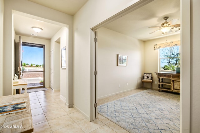 corridor featuring tile patterned floors and baseboards