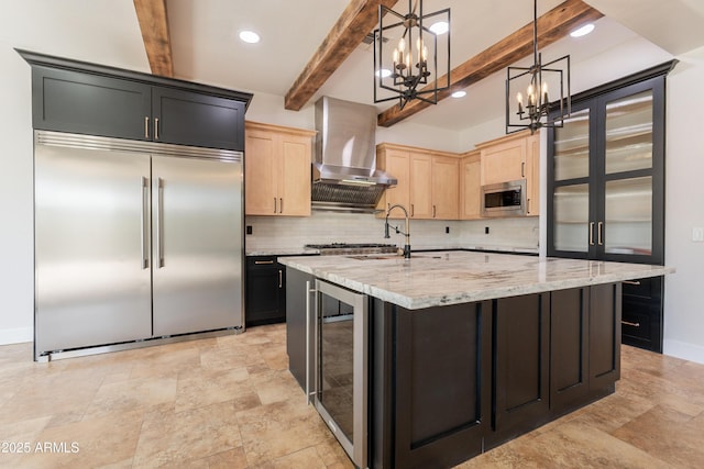 3971 E Leo Pl, Chandler, AZ 85249 - kitchen featuring built in appliances, a chandelier, wine cooler, light brown cabinetry, and wall chimney range hood