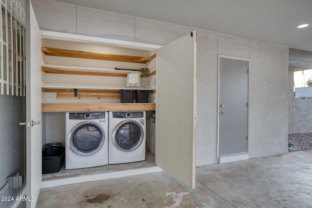 clothes washing area featuring washer and dryer