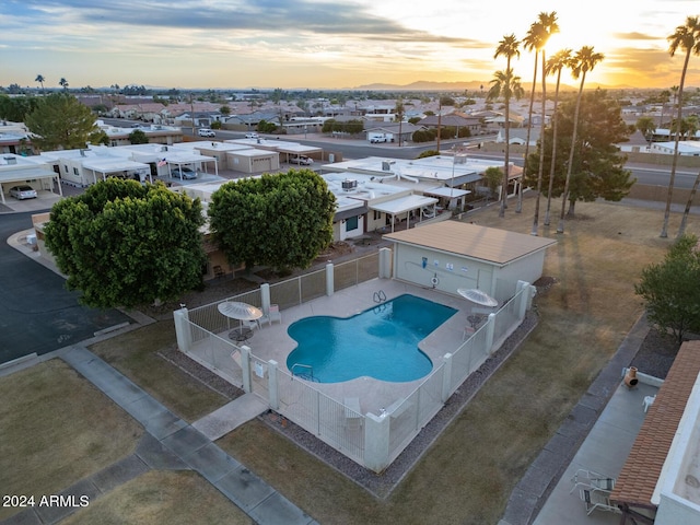 pool at dusk with a patio