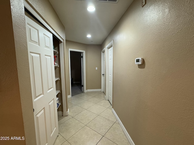 corridor featuring light tile patterned floors