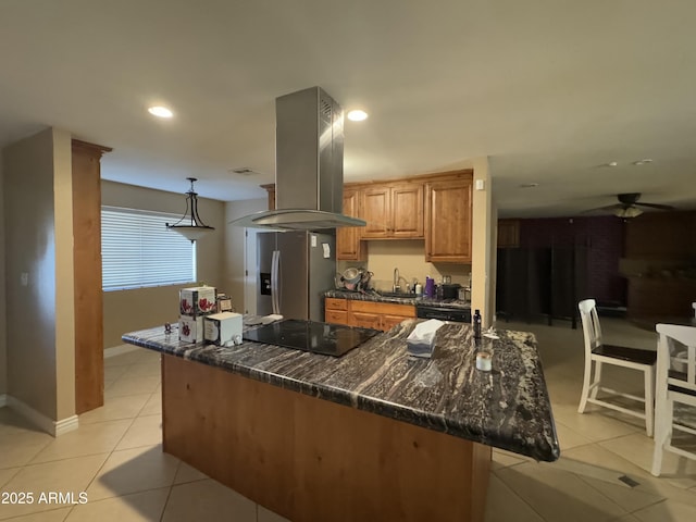 kitchen with light tile patterned flooring, island range hood, sink, stainless steel fridge, and black electric cooktop