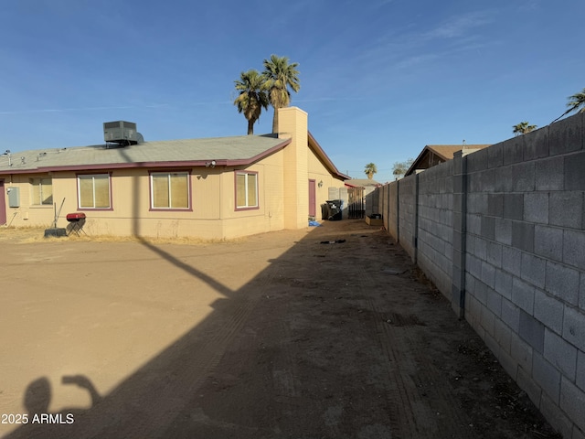 view of property exterior with central AC