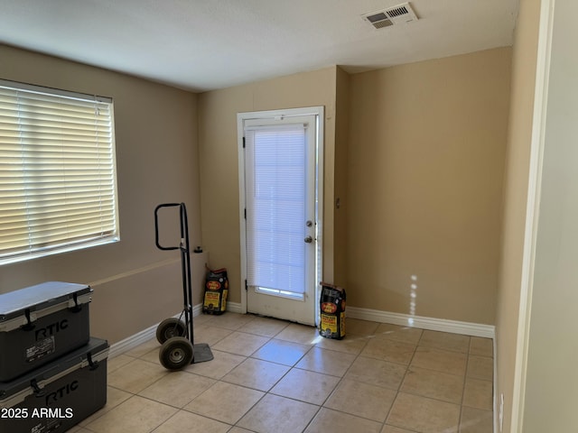 workout area featuring light tile patterned floors