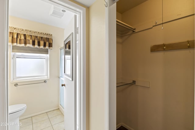 bathroom with tile patterned flooring and toilet