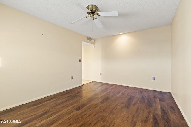 spare room featuring ceiling fan, dark hardwood / wood-style floors, and a textured ceiling