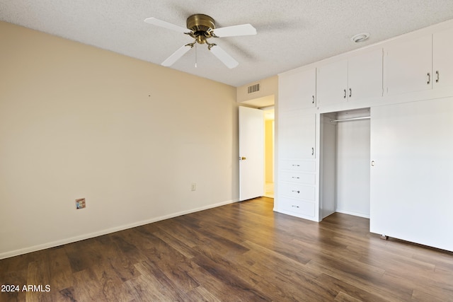 unfurnished bedroom featuring a textured ceiling, a closet, ceiling fan, and dark wood-type flooring