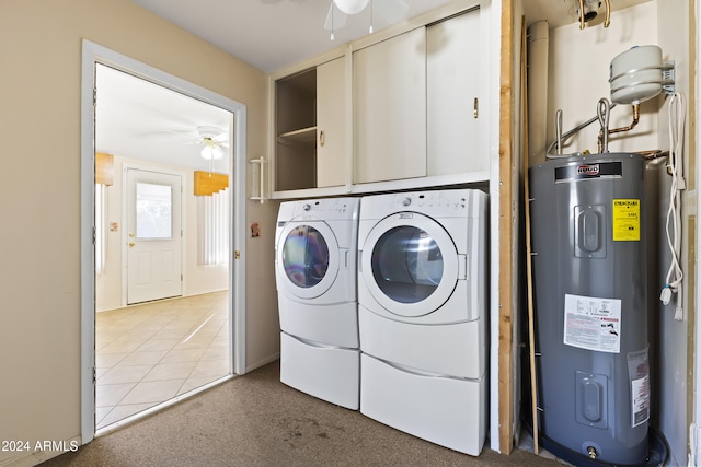 clothes washing area featuring tile patterned flooring, ceiling fan, independent washer and dryer, and water heater