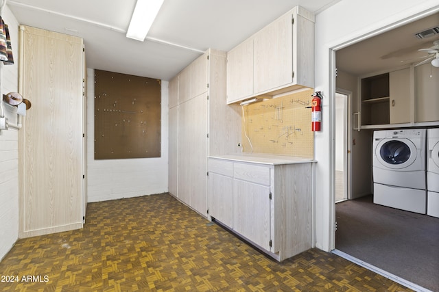 laundry area featuring dark parquet flooring, ceiling fan, cabinets, and independent washer and dryer