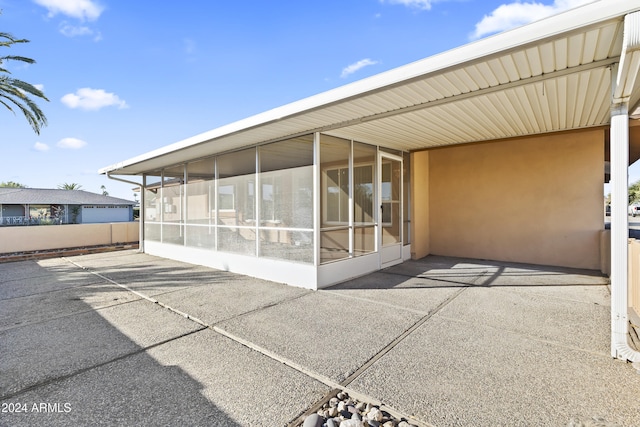 view of patio featuring a sunroom