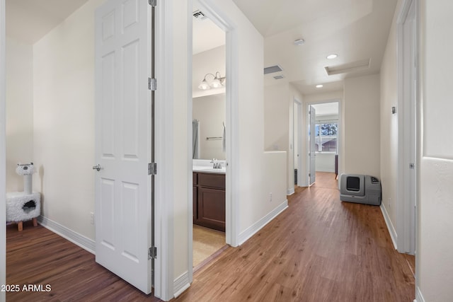2470 W Clement Cir, Flagstaff, AZ 86001 - corridor featuring light wood-style flooring, attic access, heating unit, and recessed lighting