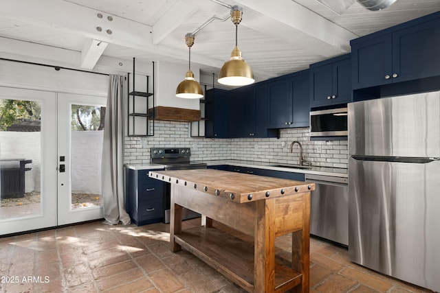 kitchen featuring appliances with stainless steel finishes, french doors, blue cabinets, beam ceiling, and decorative light fixtures