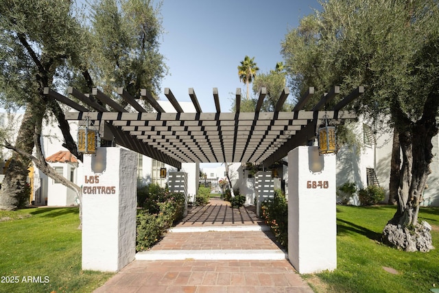 surrounding community featuring a yard and a pergola