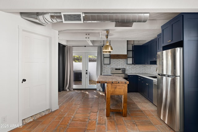 kitchen with blue cabinetry, french doors, hanging light fixtures, stainless steel appliances, and decorative backsplash