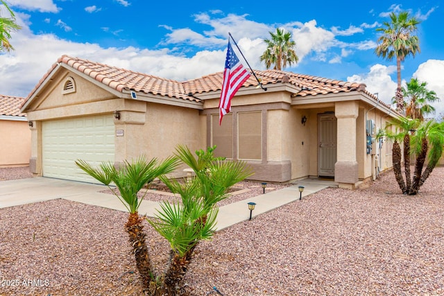 13359 W Post Dr, Surprise, AZ 85374 - mediterranean / spanish-style house with stucco siding, driveway, an attached garage, and a tile roof