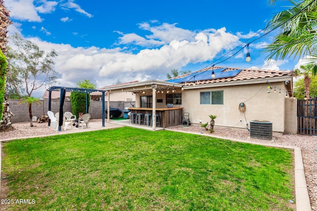 13359 W Post Dr, Surprise, AZ 85374 - rear view of house featuring stucco siding, cooling unit, a patio, a tiled roof, and roof mounted solar panels
