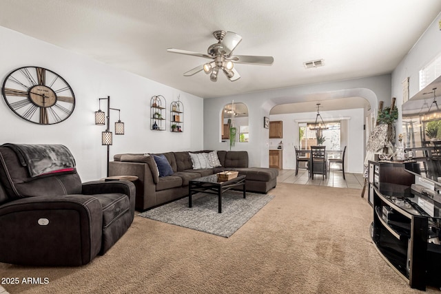 13359 W Post Dr, Surprise, AZ 85374 - living area with a chandelier, ceiling fan, arched walkways, and light carpet