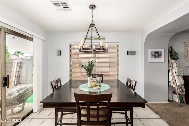 13359 W Post Dr, Surprise, AZ 85374 - dining space with a chandelier, arched walkways, and light tile patterned floors