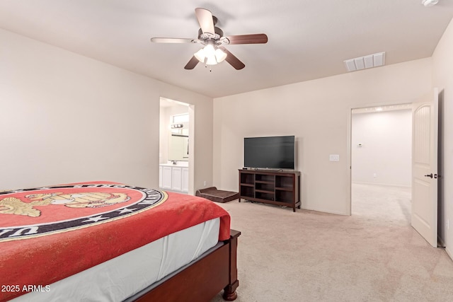 bedroom with visible vents, ensuite bathroom, baseboards, light colored carpet, and ceiling fan