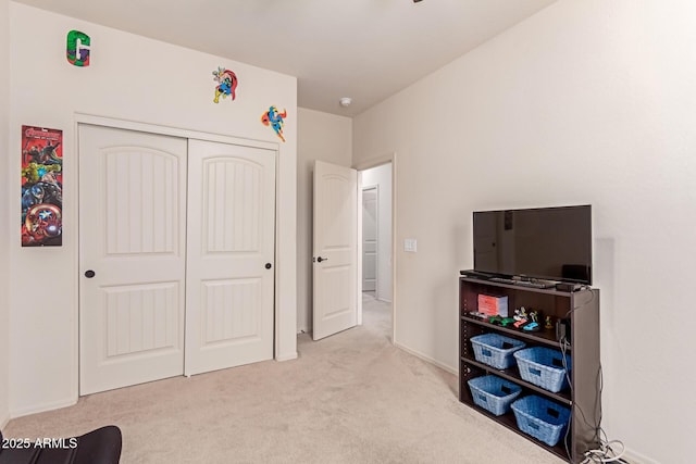 playroom featuring light colored carpet and baseboards