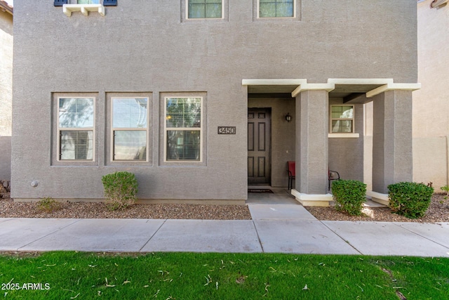 view of exterior entry with stucco siding